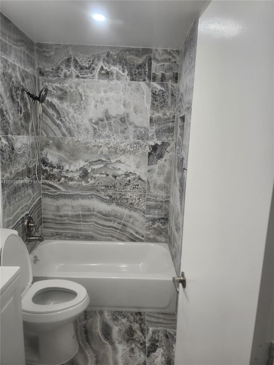 4010 Tree Top Road, Unit 4010 Cooper City, FL 33026 - Photo 5 of 12 a bathroom with a toilet and a bathtub