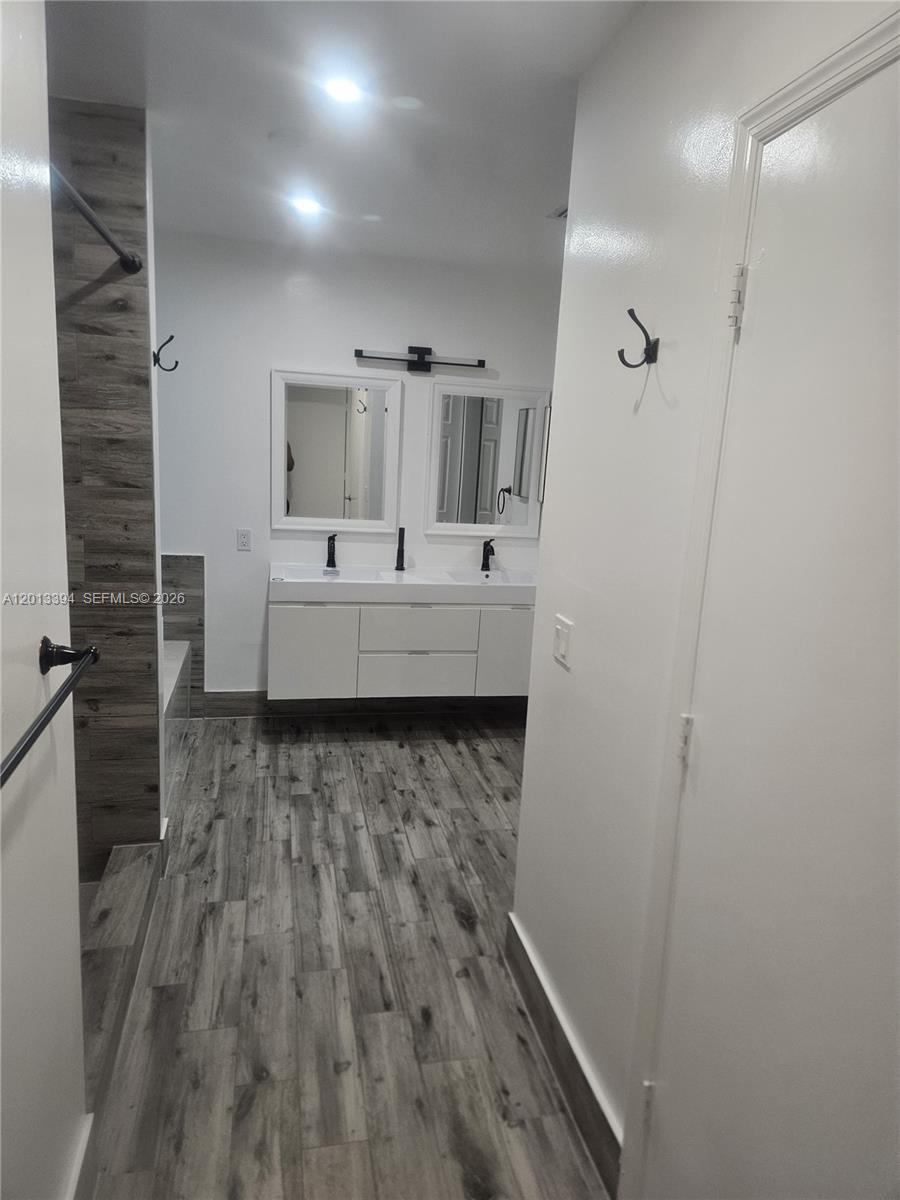 4010 Tree Top Road, Unit 4010 Cooper City, FL 33026 - Photo 6 of 12 a large bathroom with a sink and mirror