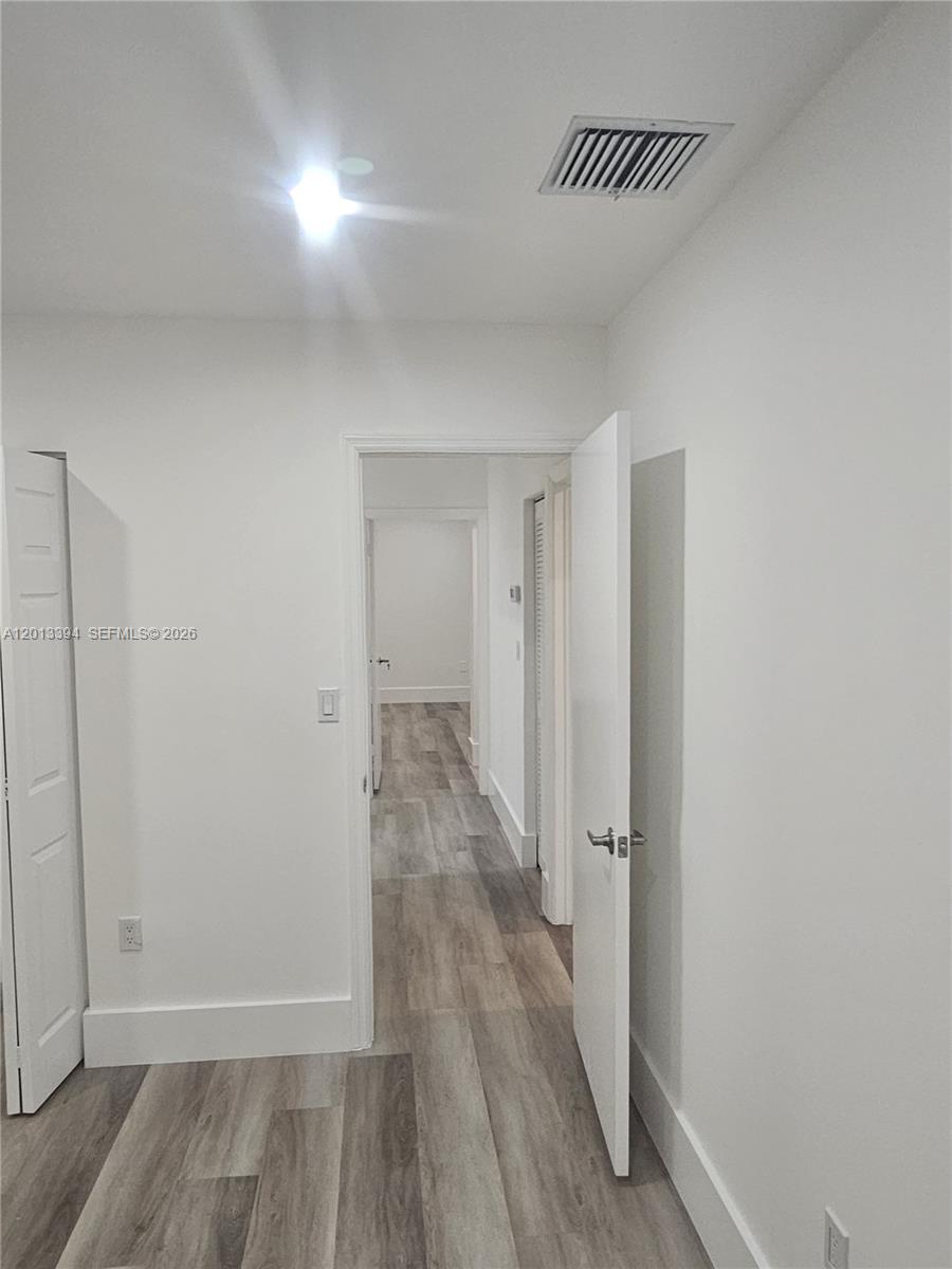 4010 Tree Top Road, Unit 4010 Cooper City, FL 33026 - Photo 9 of 12 a view of a hallway with wooden floor