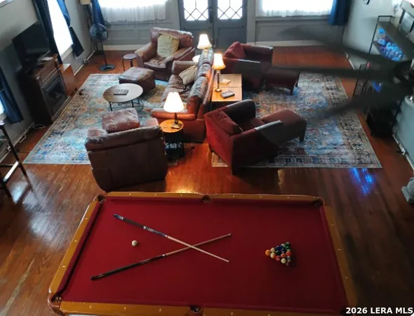 a view of a dining room with furniture window and wooden floor