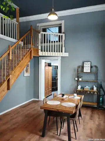 a dining room with furniture and wooden floor