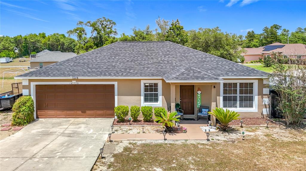 14978 Southwest 46th Circle Ocala, FL 34473 - Photo 1 of 1 a front view of house with yard and trees in the background