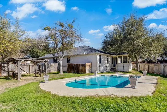 a view of a house with swimming pool and sitting area
