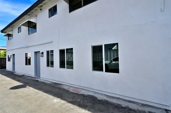 a view of building with car parked