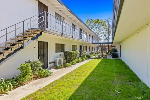 a view of a house with backyard and sitting area
