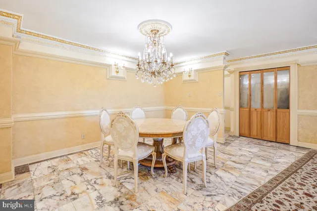 a view of a dining room with furniture and chandelier