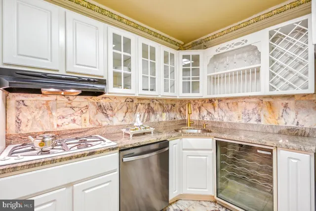 a kitchen with granite countertop a sink and a stove