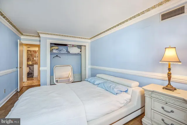 a bedroom with a bed and wooden floor