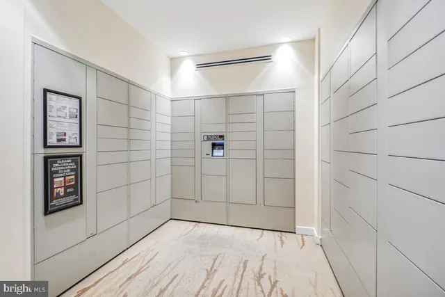 a front view of a house with a yard and potted plants