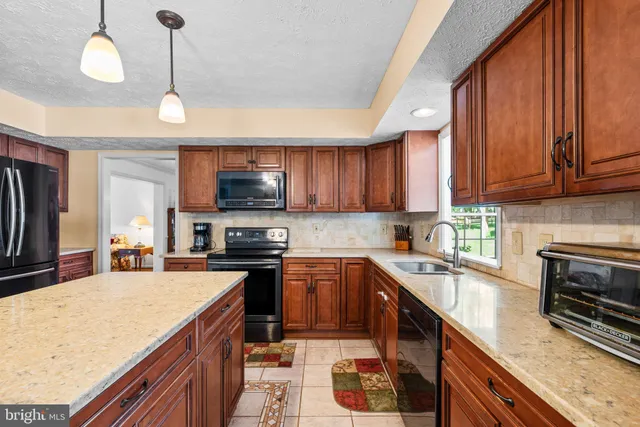 a kitchen with a table chairs and a view of kitchen