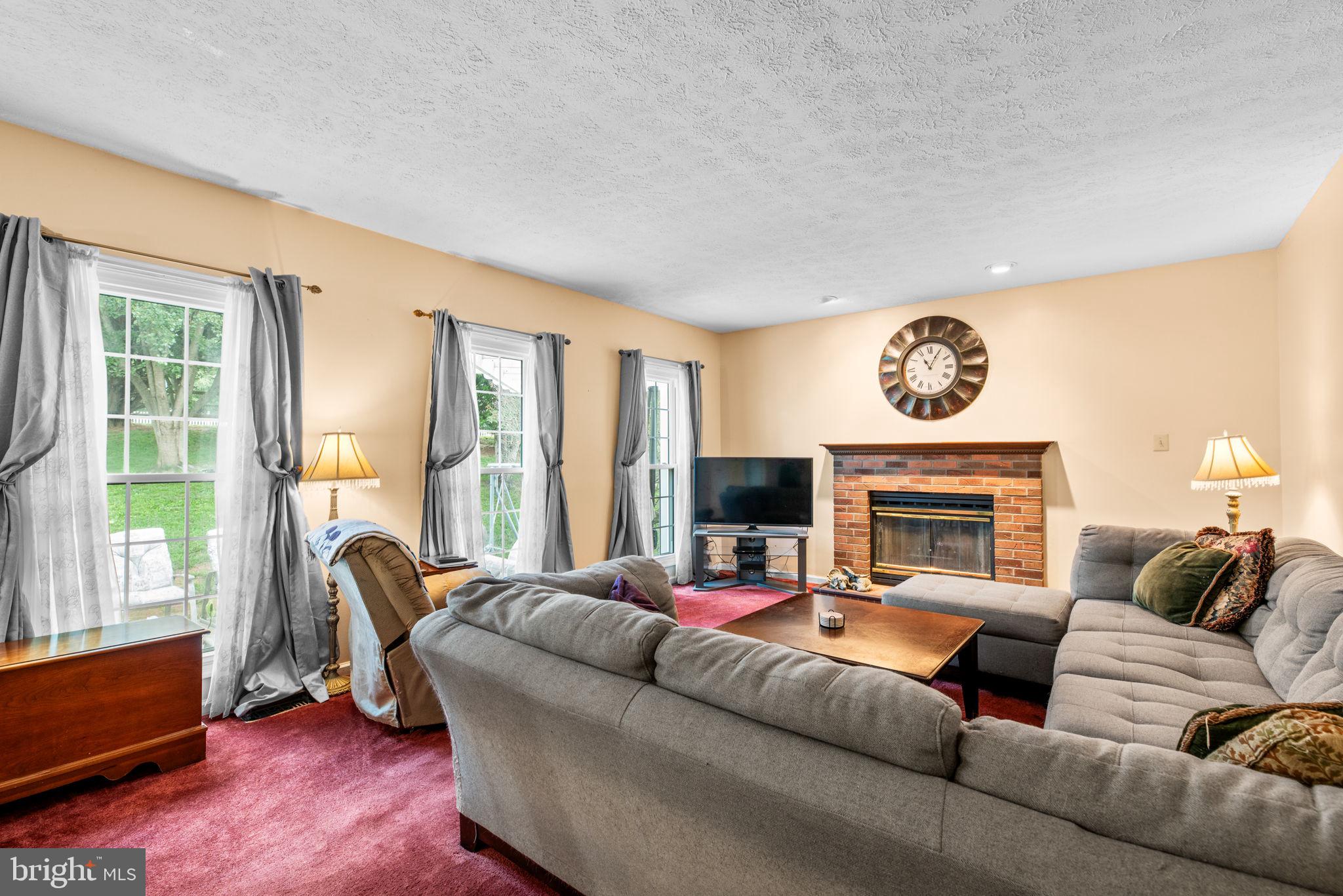 9464 Joppa Pond Road Baltimore, MD 21234 - Photo 22 of 66 a living room with furniture and a fireplace