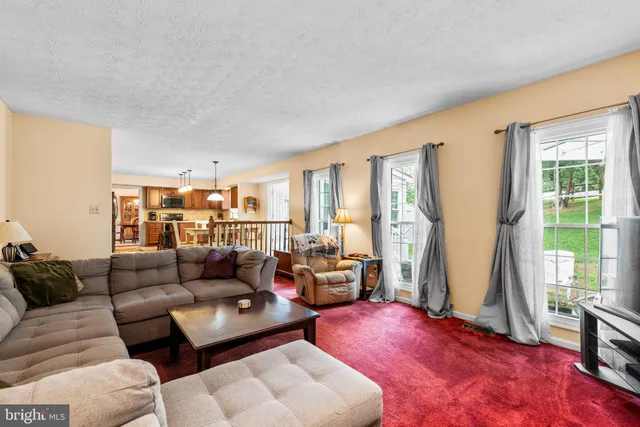 a living room with furniture and a book shelf