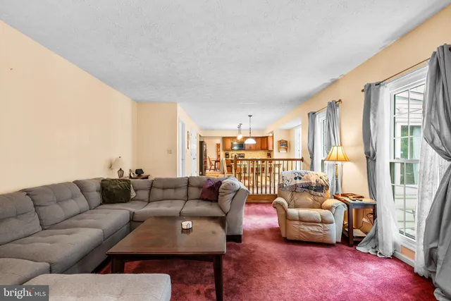 a living room with furniture a table and a window