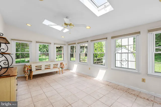 a living room with furniture a rug and a bookshelf