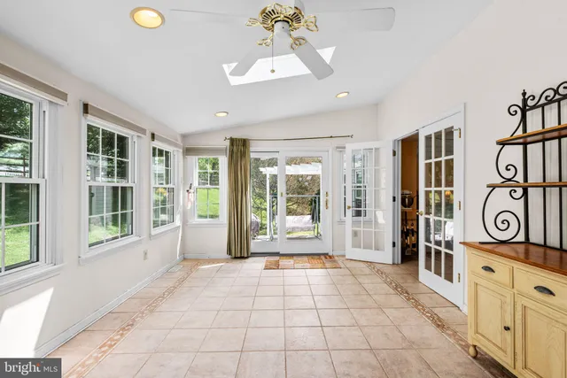 a bedroom with a bed mirror and window