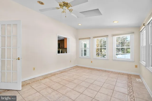 a living room with furniture a rug and a bookshelf