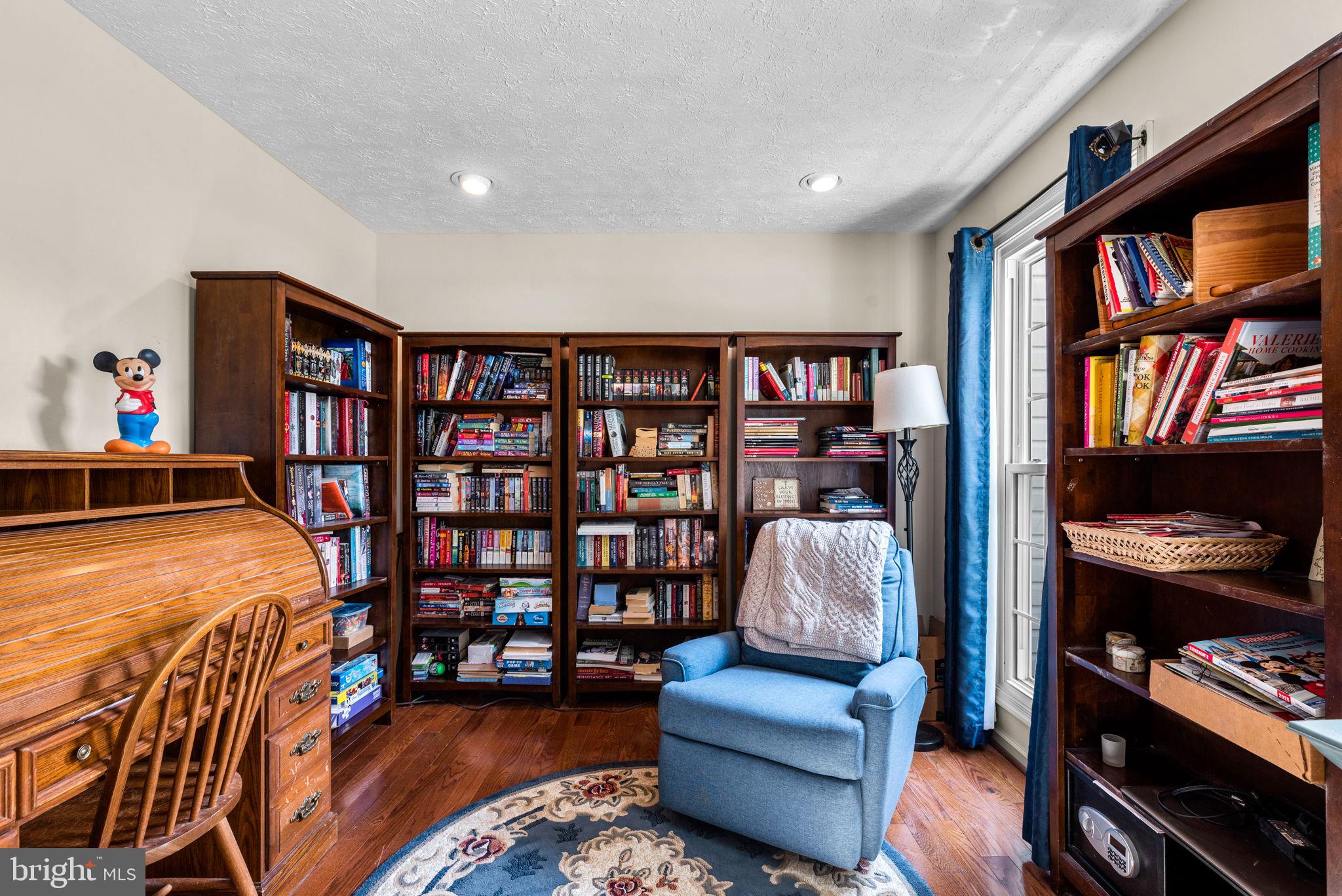 9464 Joppa Pond Road Baltimore, MD 21234 - Photo 30 of 66 a living room with furniture and a book shelf