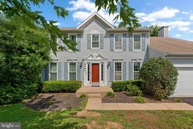 a front view of a house with a yard and potted plants