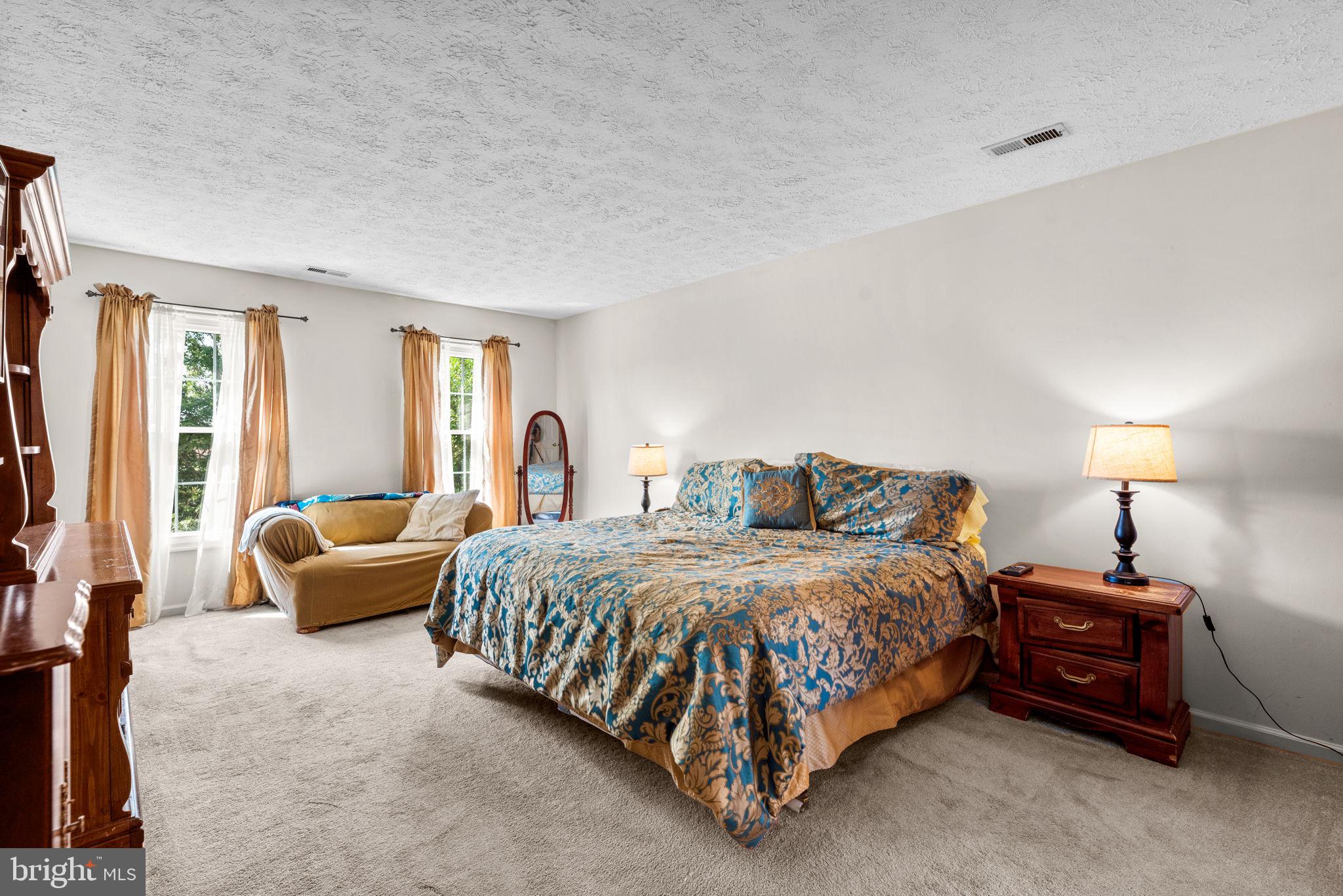 9464 Joppa Pond Road Baltimore, MD 21234 - Photo 32 of 66 a spacious bedroom with a bed and a couch