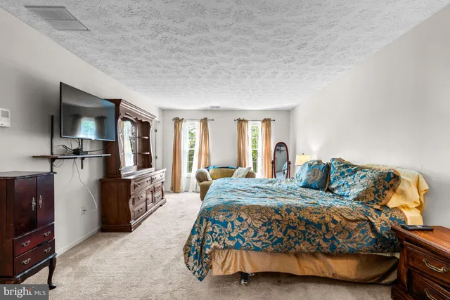 a bedroom with a bed and a lamp