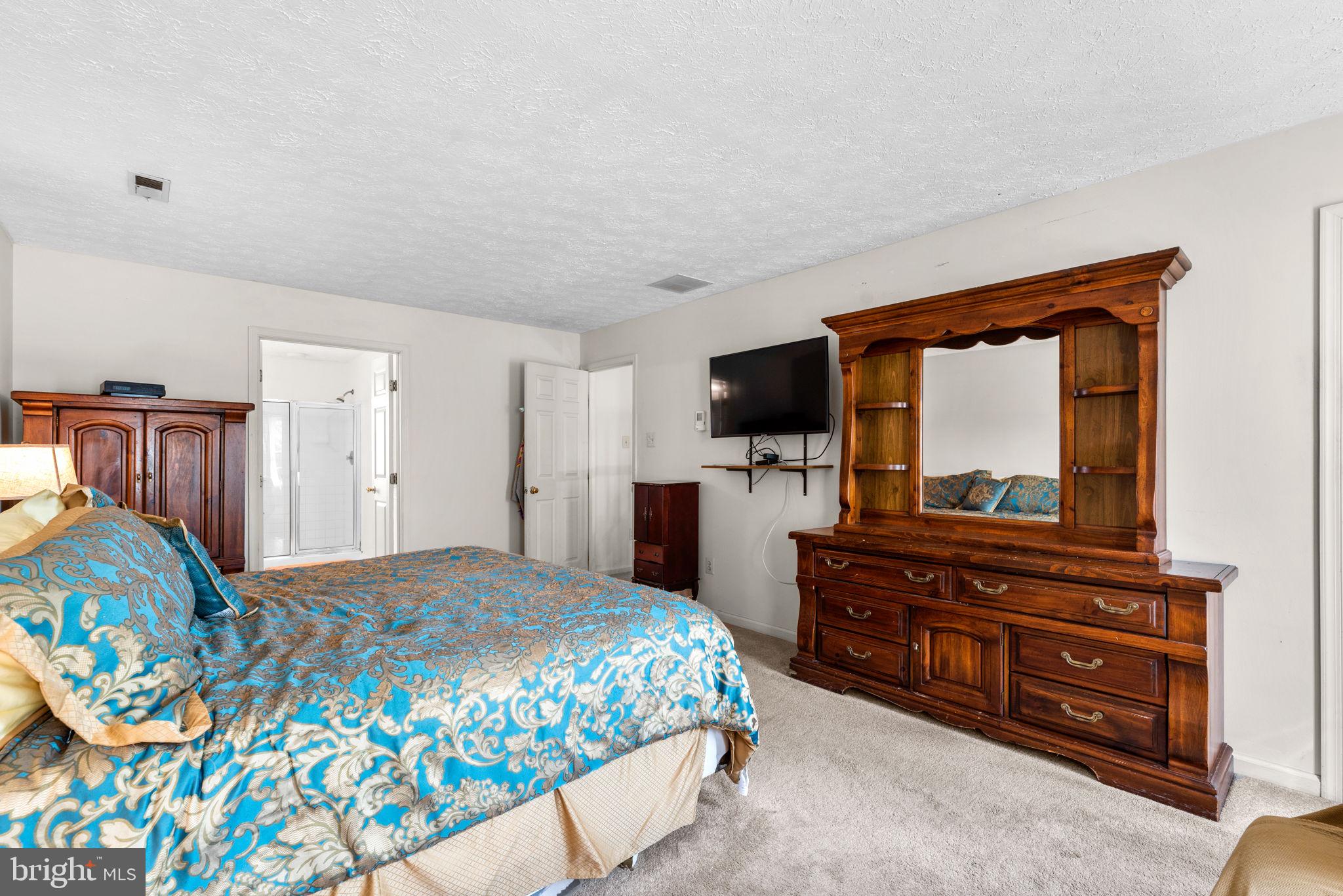 9464 Joppa Pond Road Baltimore, MD 21234 - Photo 35 of 66 a bedroom with a bed and a flat screen tv