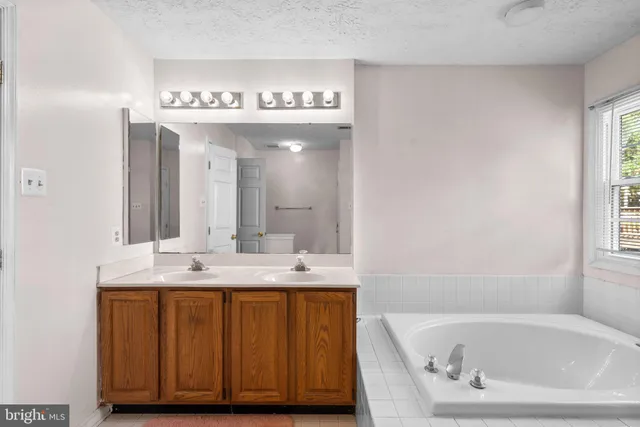 a spacious bedroom with a bed and a table