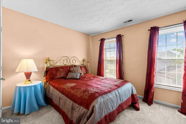 a bedroom with a bed and a chair in it