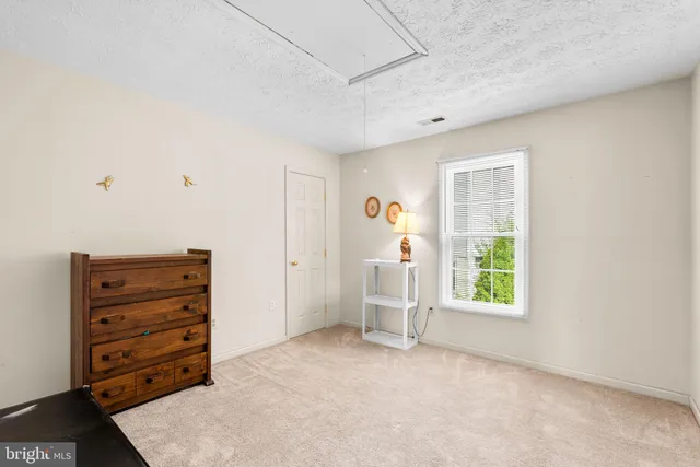 a living room with furniture a rug and a lamp