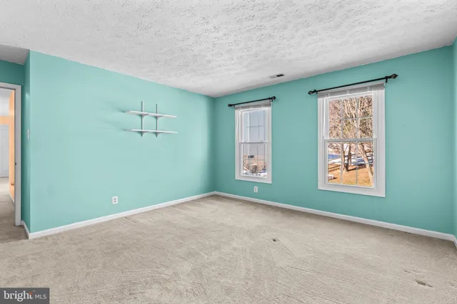 a view of a patio with chairs and a table