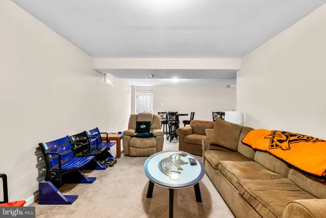 a front view of a house with garden and outdoor seating