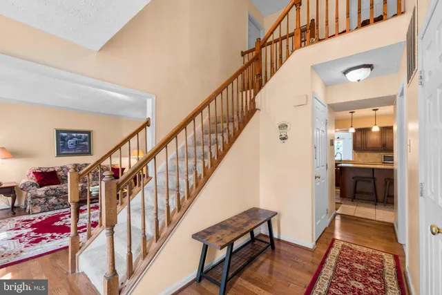 a view of staircase with lots of frames on wall and a rug