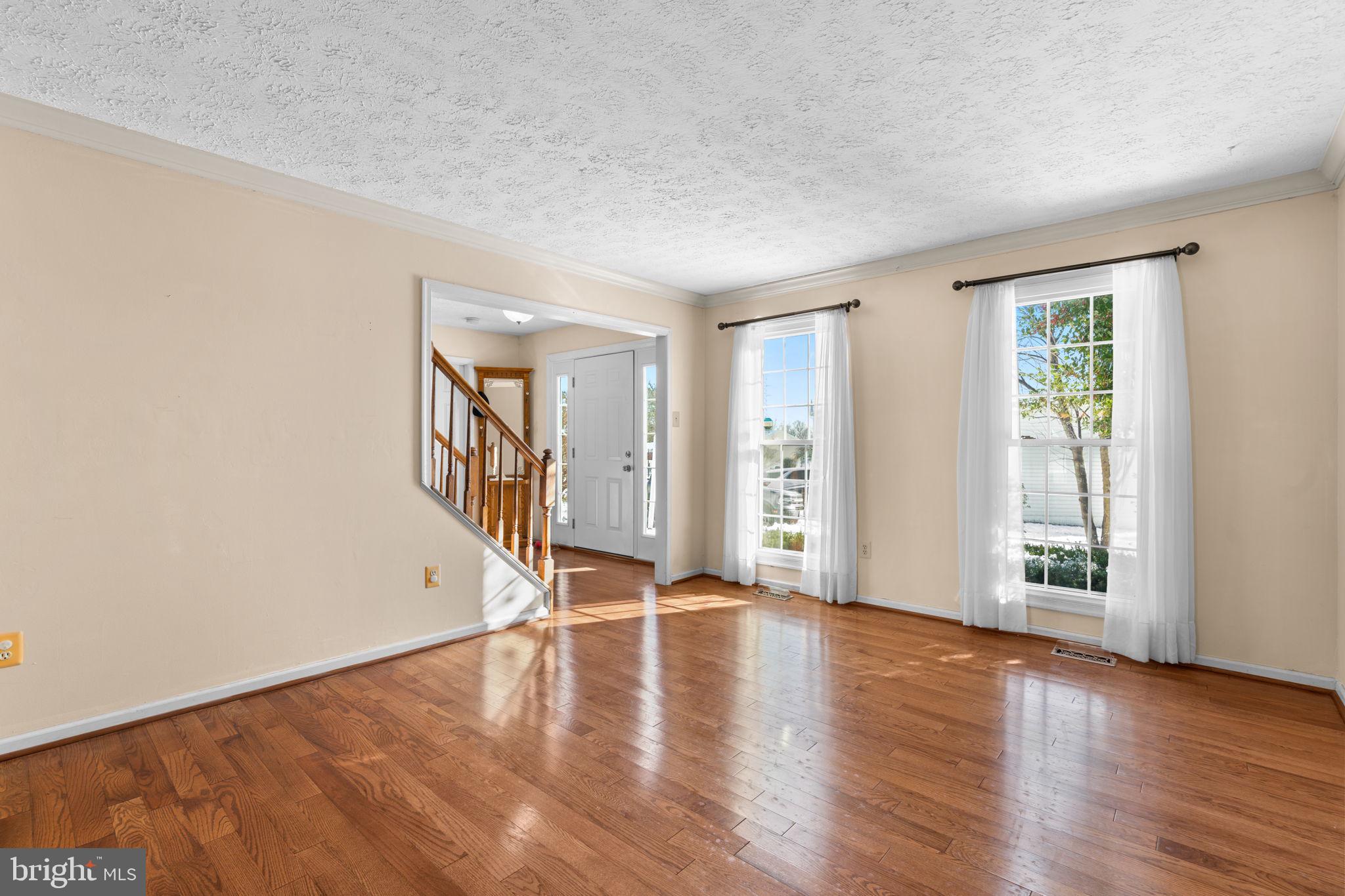 9464 Joppa Pond Road Baltimore, MD 21234 - Photo 5 of 66 a view of an empty room with wooden floor and a window