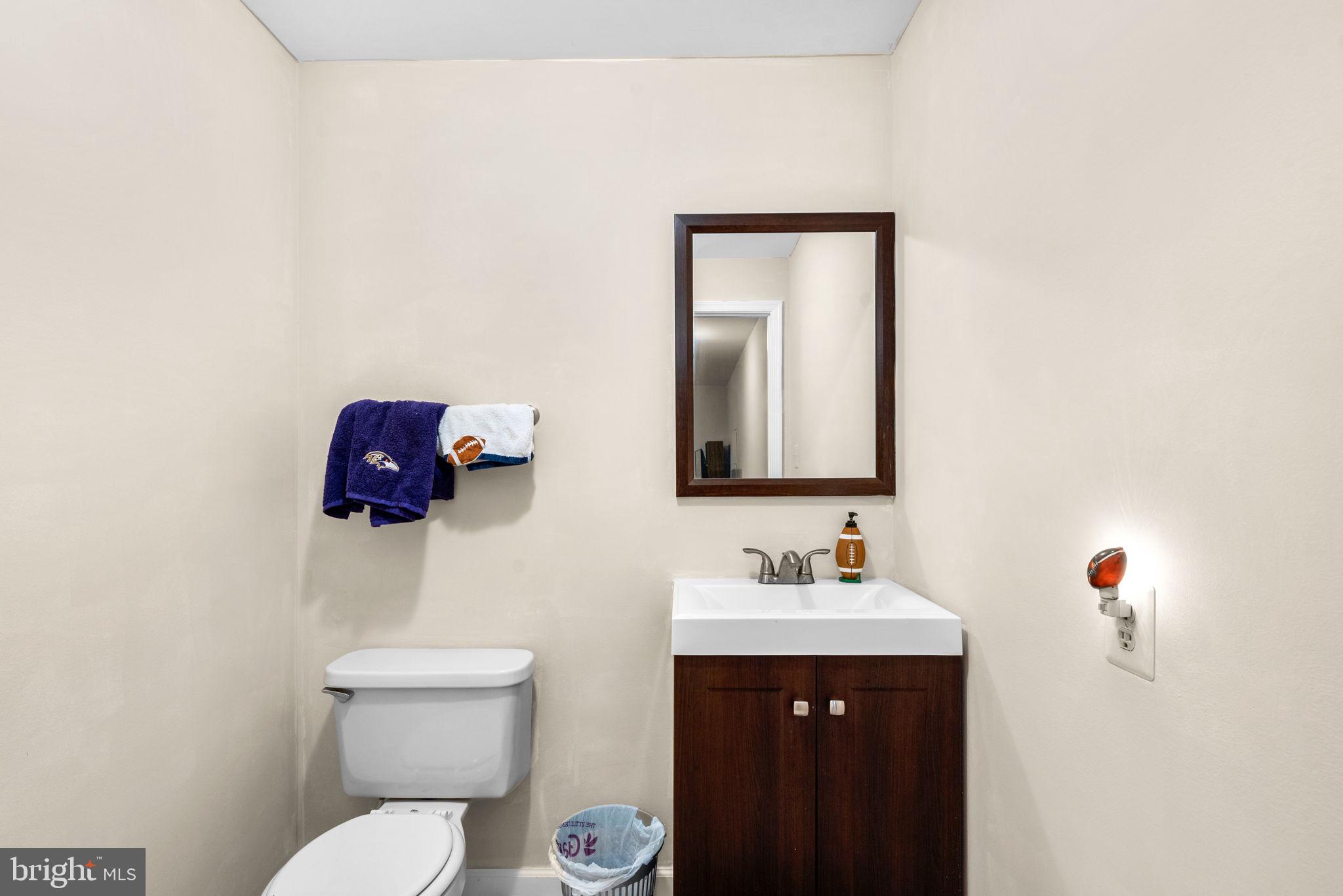 9464 Joppa Pond Road Baltimore, MD 21234 - Photo 51 of 66 a bathroom with a toilet sink and mirror