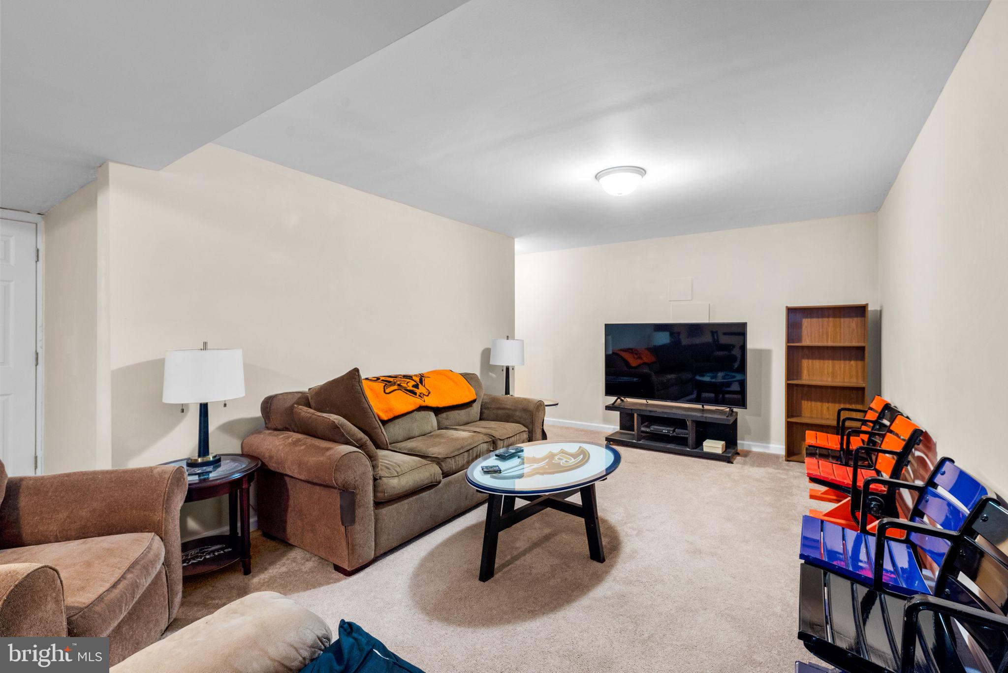 9464 Joppa Pond Road Baltimore, MD 21234 - Photo 57 of 66 a living room with furniture and a flat screen tv