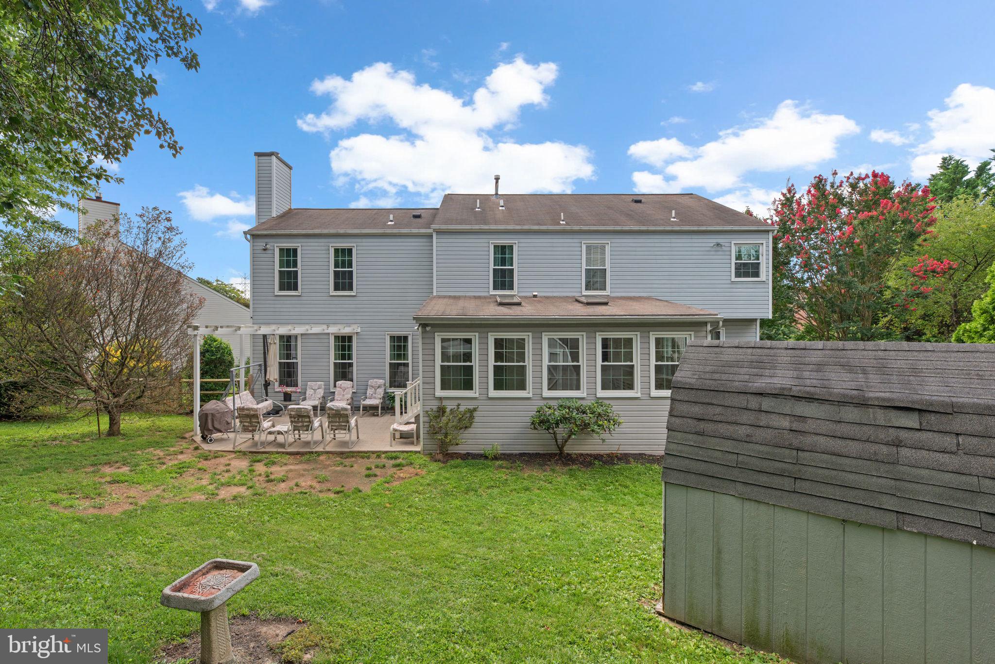 9464 Joppa Pond Road Baltimore, MD 21234 - Photo 62 of 66 a front view of a house with garden and outdoor seating