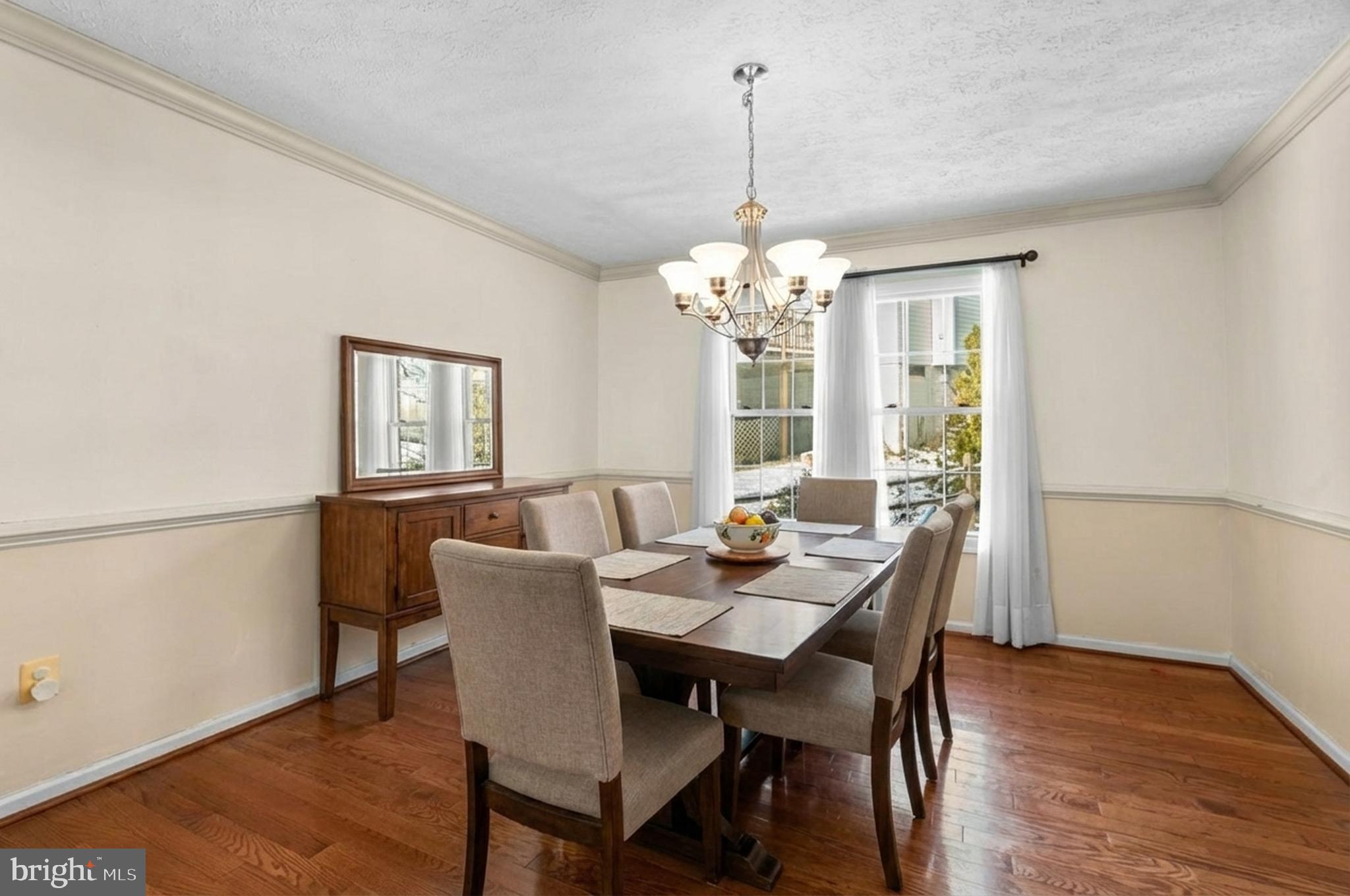 9464 Joppa Pond Road Baltimore, MD 21234 - Photo 10 of 66 a view of a dining room with furniture a chandelier and wooden floor