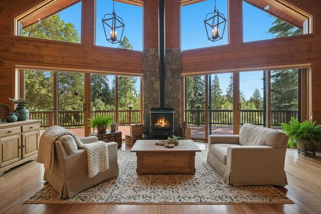 a living room with furniture and large windows