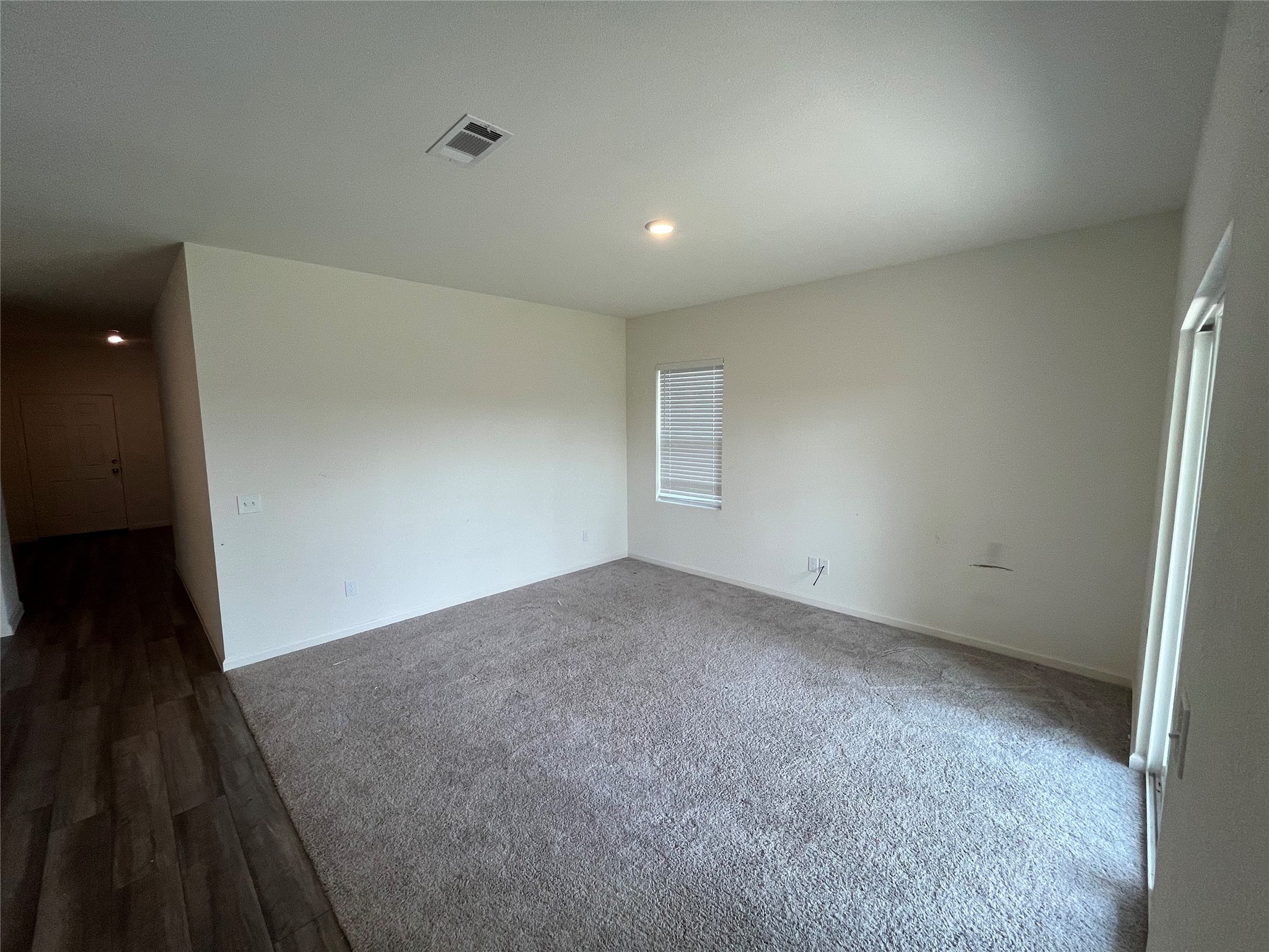14715 Peaceful Way New Caney, TX 77357 - Photo 11 of 17 an empty room with wooden floor and entrance