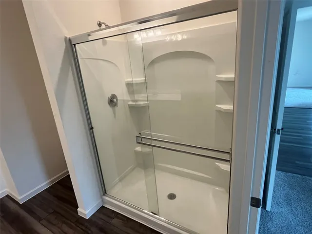 a bathroom with a glass shower door