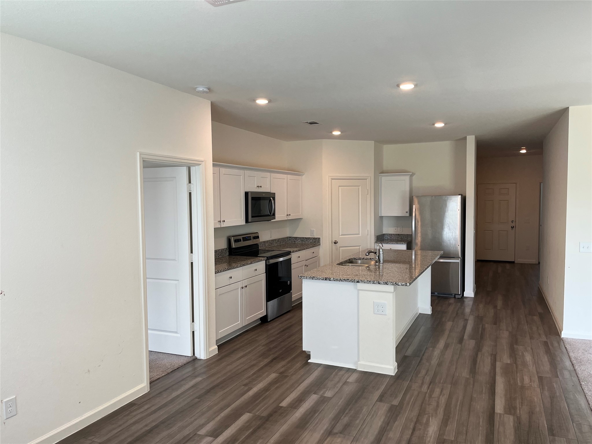 14715 Peaceful Way New Caney, TX 77357 - Photo 6 of 17 a kitchen with a sink a refrigerator and cabinets
