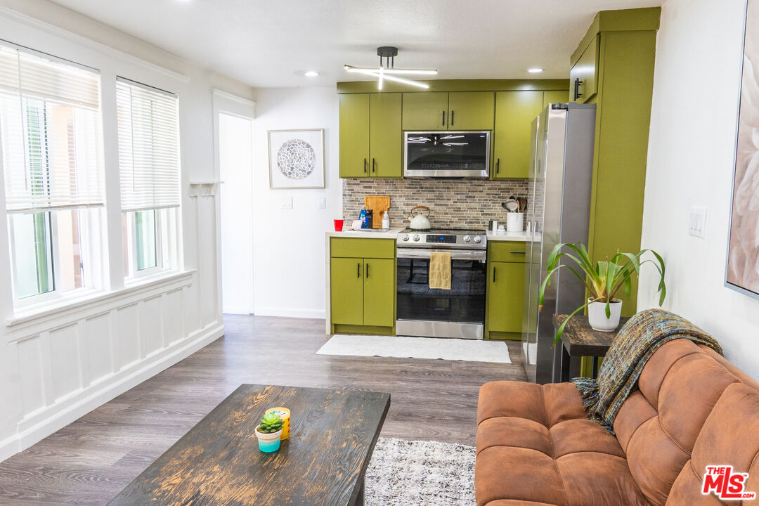 348 Laveta Terrace, Unit 2 Los Angeles, CA 90026 - Photo 16 of 20 a living room with stainless steel appliances furniture stove and a kitchen view