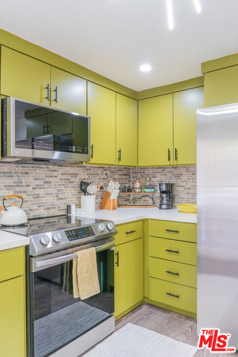 348 Laveta Terrace, Unit 2 Los Angeles, CA 90026 - Photo 8 of 20 a kitchen with a sink stove and cabinets