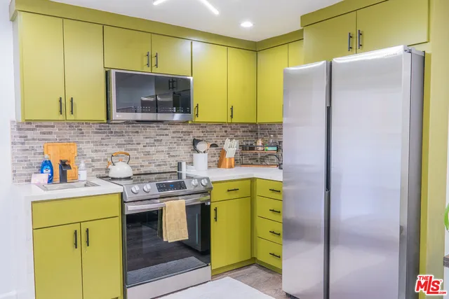 a kitchen with a sink appliances and cabinets