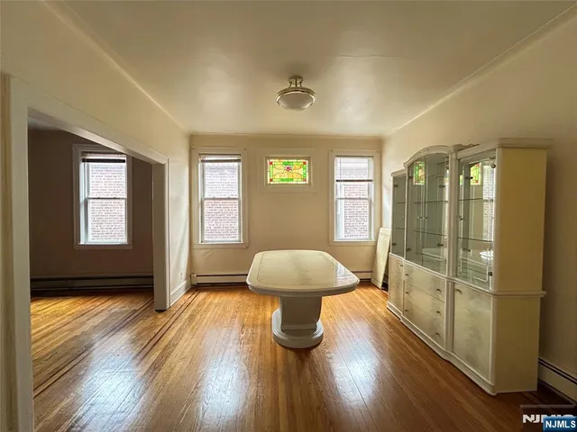 a view of a livingroom with furniture wooden floor and windows