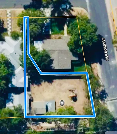 an aerial view of a house with a yard and garden