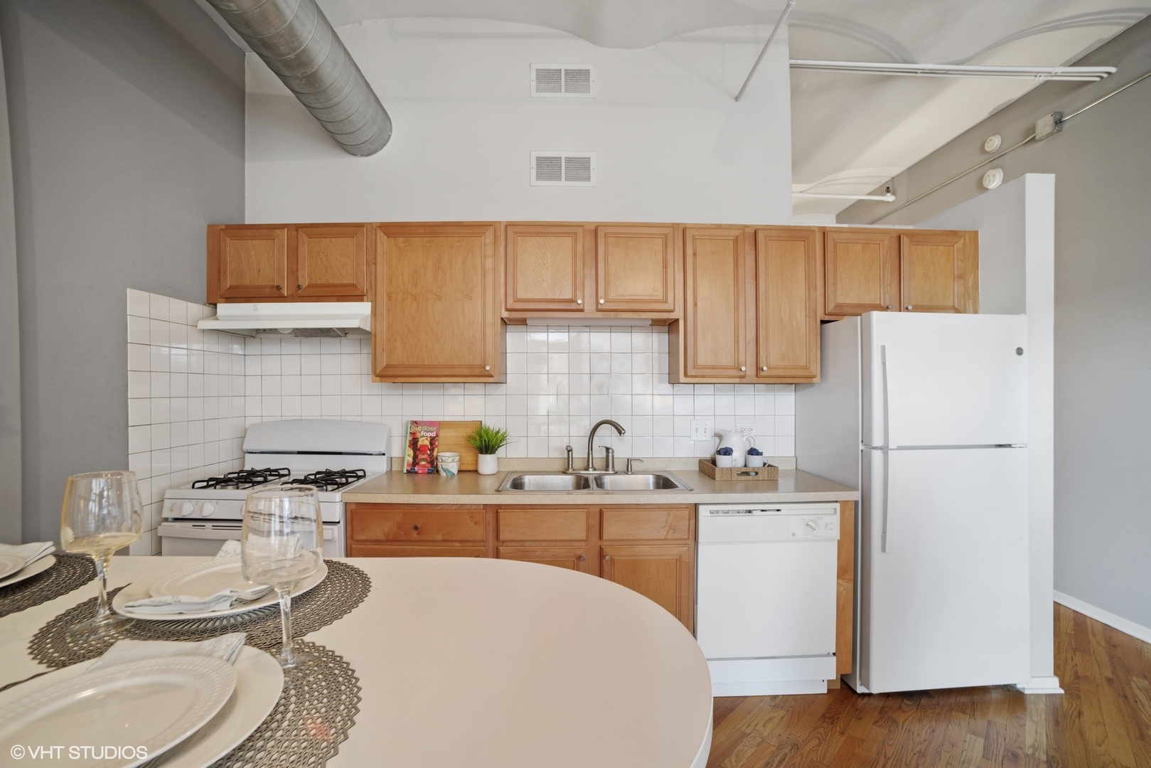 500 South Clinton Street, Unit 217 Chicago, IL 60607 - Photo 4 of 11 a kitchen with a sink a stove a refrigerator and cabinets