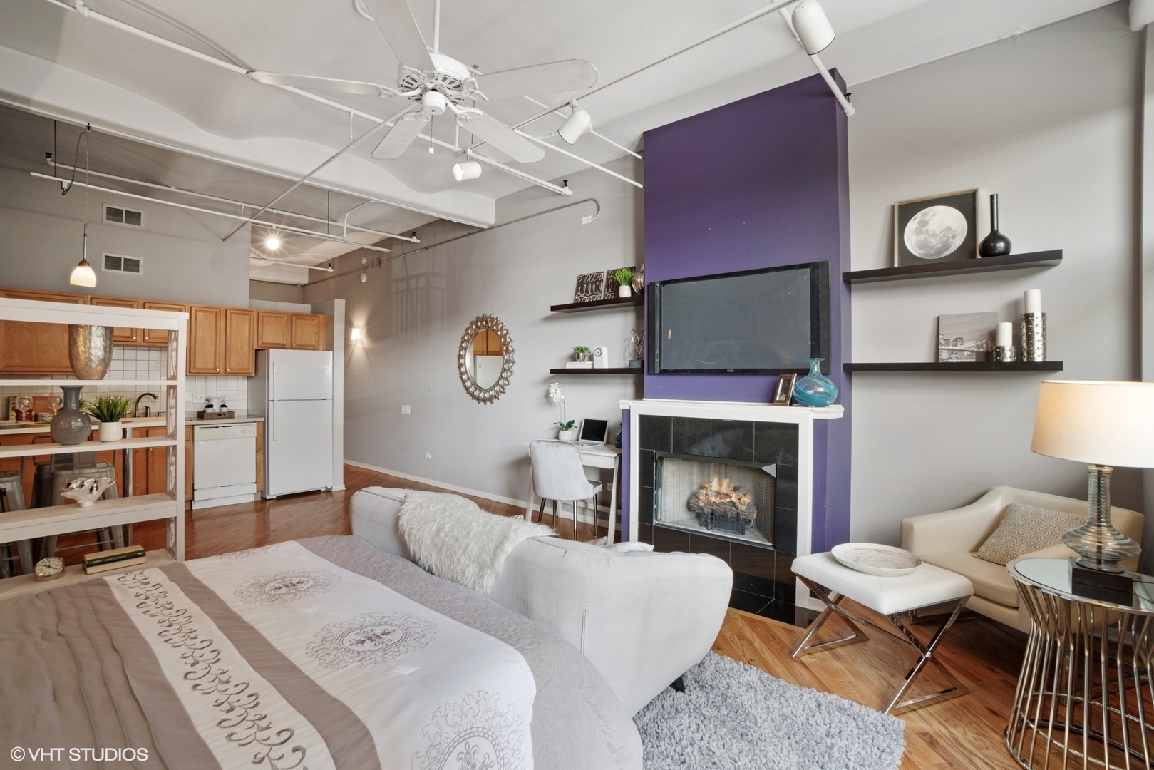 500 South Clinton Street, Unit 217 Chicago, IL 60607 - Photo 7 of 11 a living room with furniture a flat screen tv and a fireplace