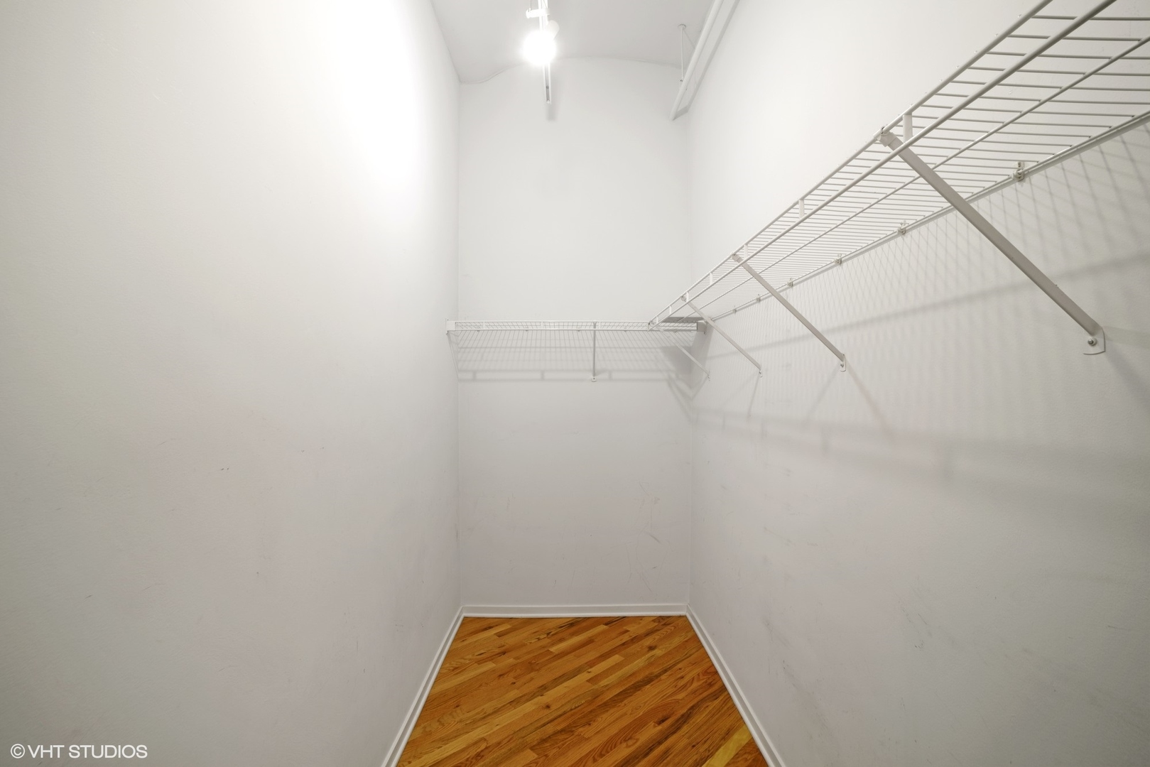 500 South Clinton Street, Unit 217 Chicago, IL 60607 - Photo 9 of 11 a view of a room with racks on the wall