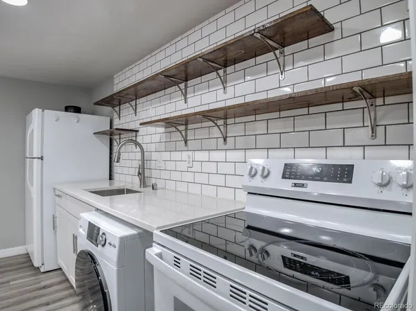 a kitchen with stainless steel appliances granite countertop a stove and a sink