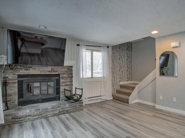 a kitchen with stainless steel appliances granite countertop a stove and a wooden floors